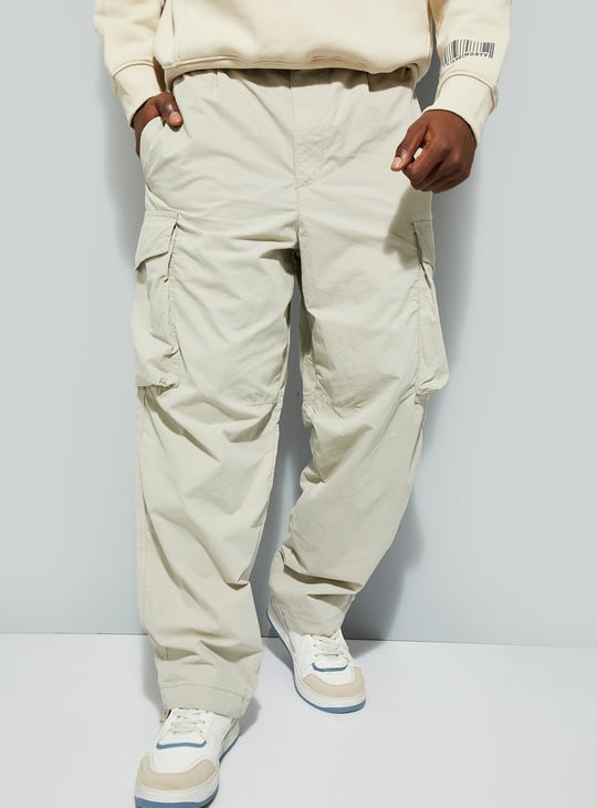 URB_N Men Solid Parachute Pants with Cargo Pockets Off White Solid