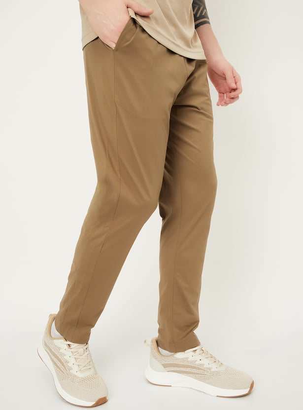 Buy Men Solid Slim Fit Track Pants Online at just Rs. 999.0